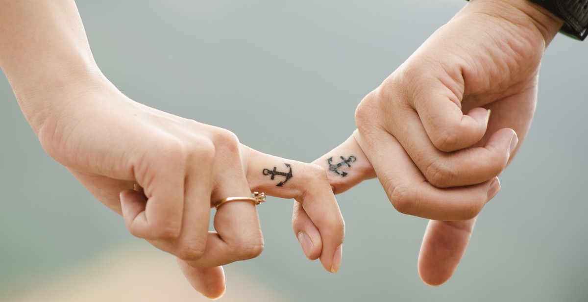 couple holding hands with friends