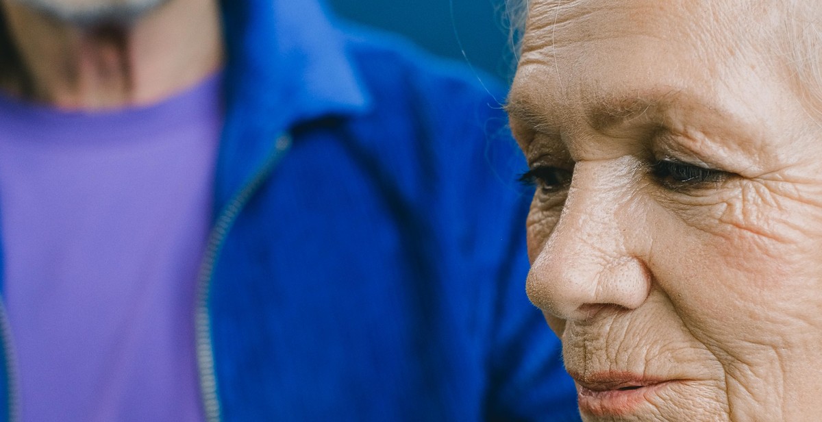 elderly couple holding hands